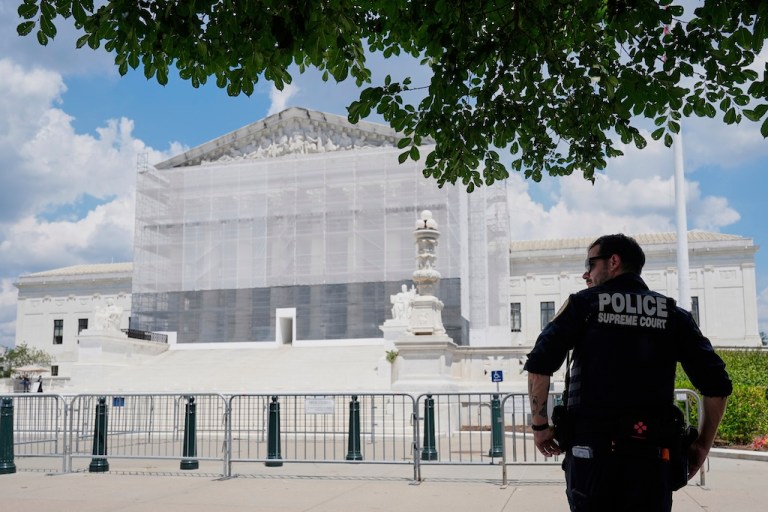 A U.S. Supreme Court police officer stands watch outside of the Supreme Court, June 26, 2025, in Washington. (AP Photo/Mariam Zuhaib)