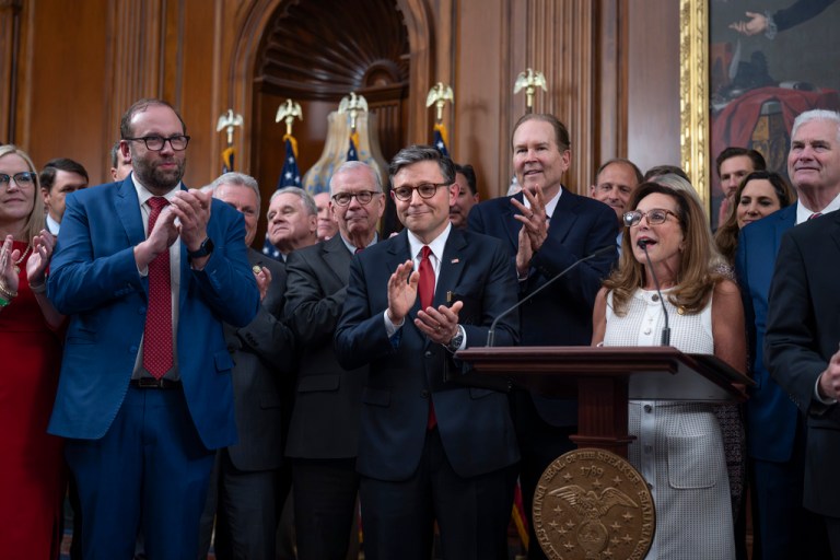 Speaker of the House Mike Johnson, R-La., center, is joined by House Ways and Means Committee Chair Jason Smith, R-Mo., left, and Rep. Lisa McClain, R-Mich., chair of the House Republican Conference, right, as Republicans celebrate after final passage of President Donald Trump's signature bill of tax breaks and spending cuts, at the Capitol in Washington, Thursday, July 3, 2025. (AP Photo/J. Scott Applewhite)