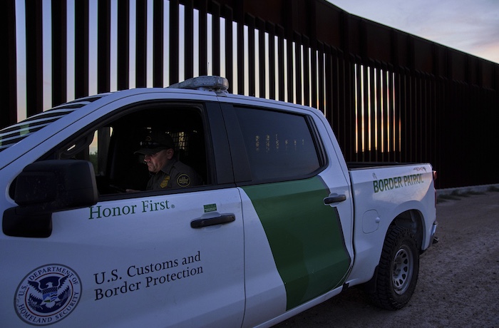 A border patrol agent works by a section of the border wall, Wednesday, June 18, 2025,