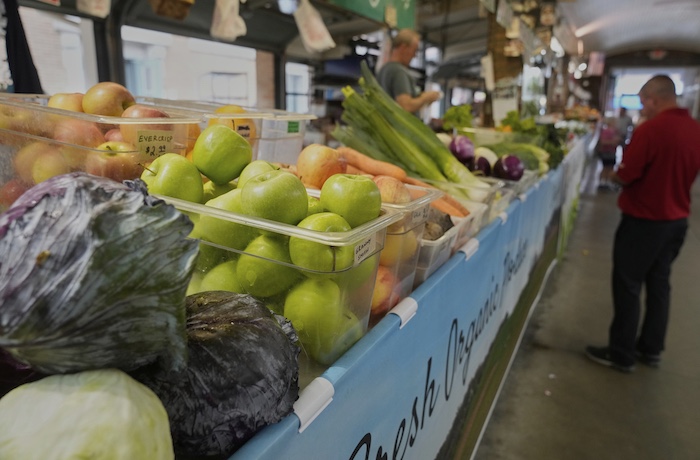 A customer purchases produce at West Side Market in Cleveland, Wednesday, July 16, 2025.