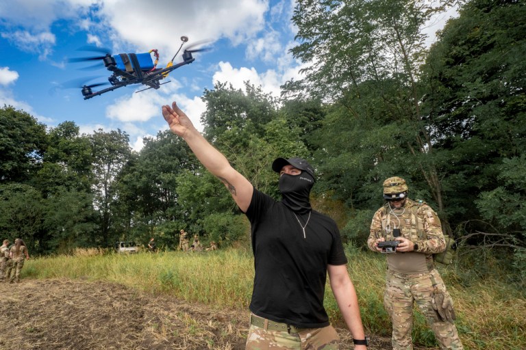 A Ukrainian serviceman from the 57th motorized brigade controls an FPV drone.
