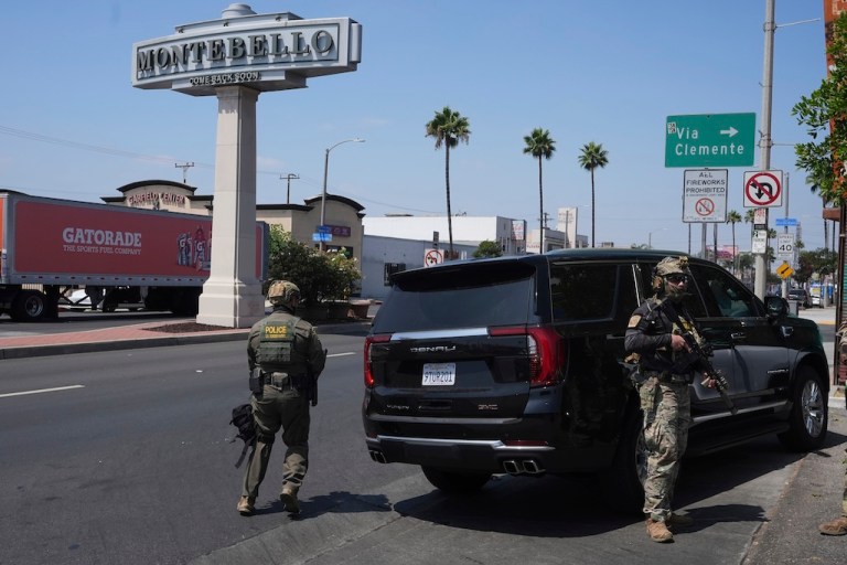 Immigration agents conduct an operation at a car wash.
