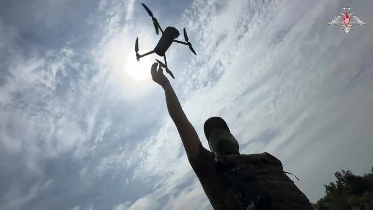 A russian soldier launches a reconnaissance drone.