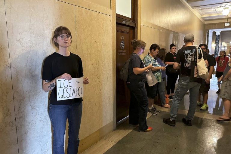 Emily Pietrzak holds a sign that reads 
