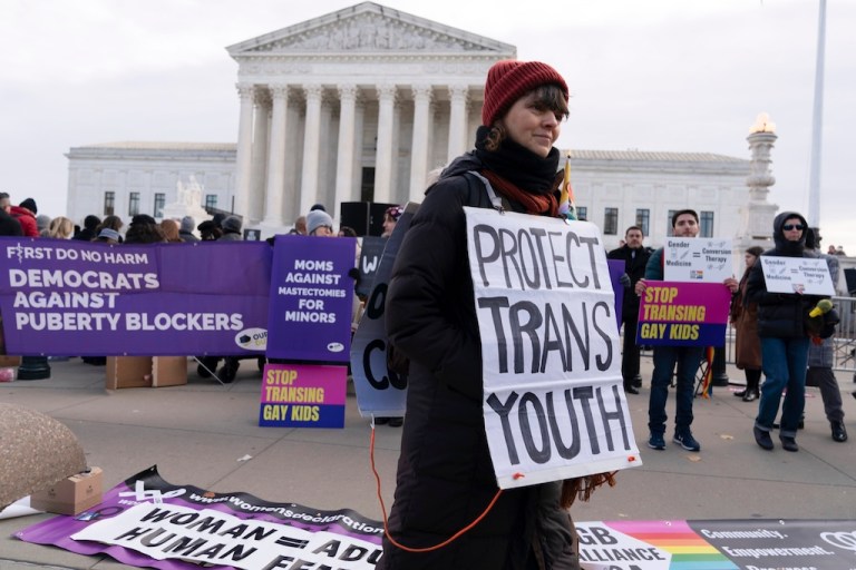 FILE - Protesters for and against transgender procedures for minors demonstrate outside the Supreme Court on Dec. 4, 2024, in Washington. (AP Photo/Jose Luis Magana, File)