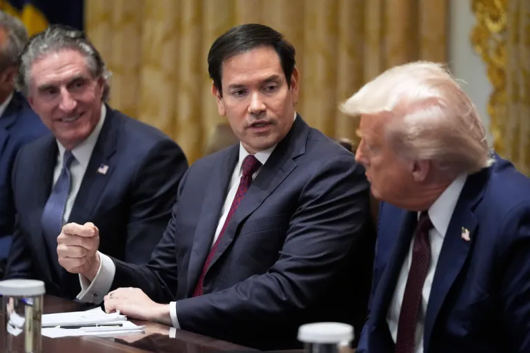 President Donald Trump listens as Secretary of State Marco Rubio speaks. Interior Secretary Doug Burgum sits on the left.