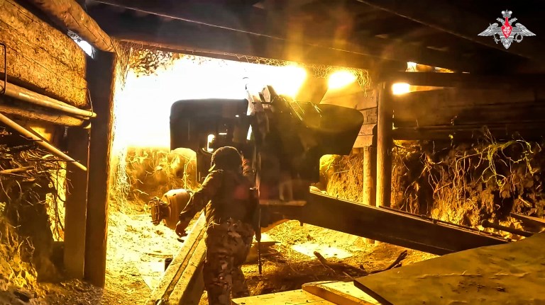 A Russian soldier fires a 152 mm howitzer 2A65 Msta-B toward a Ukrainian position in an undisclosed location in Ukraine.