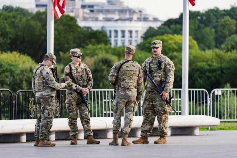FILE - With the White House in the distance, National Guard troops patrol the Mall as part of President Donald Trump's order to impose federal law enforcement in the nation's capital, in Washington, Aug. 28, 2025.