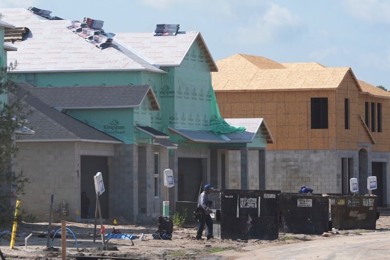 Workers build new single family homes Wednesday, July 30, 2025, in Zephyrhills, Fla. (AP Photo/Marta Lavandier)