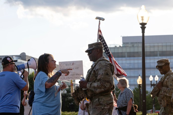 A protester confronts a member of the D.C. National Guard at Union Station.