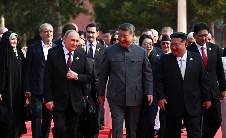 Vladimir Putin, Xi Jinping, and Kim Jon Un walk together during China's military parade celebrating the end of World War II.