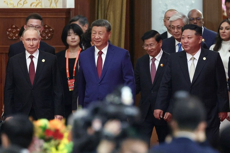 From left, Russian President Vladimir Putin, Chinese President Xi Jinping and North Korean leader Kim Jong Un arrive at a reception.