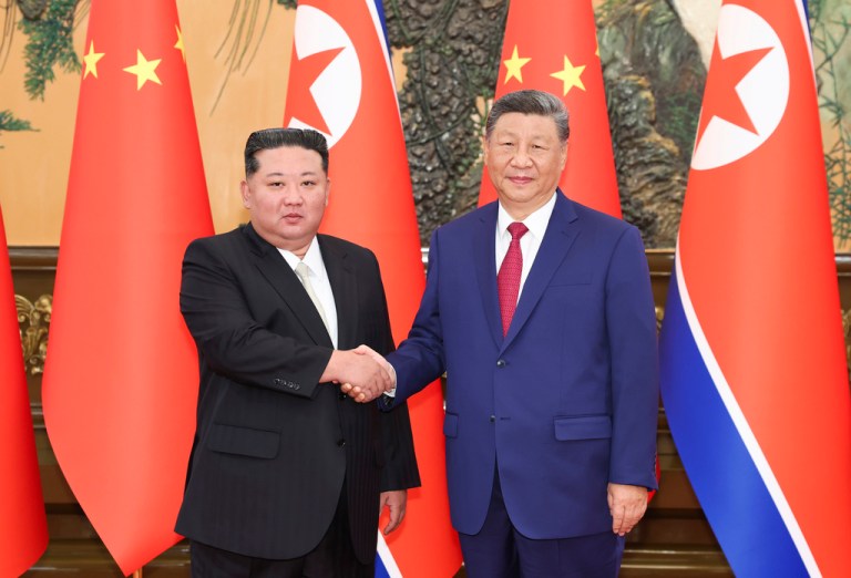 In this photo released by Xinhua News Agency, Chinese President Xi Jinping, right, poses for photos with North Korean leader Kim Jong Un at the Great Hall of the People in Beijing, China, Thursday, Sept. 4, 2025.