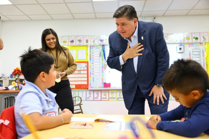 Gov. J.B. Pritzker speaks with kindergarten student at Prairie Oak Elementary School at 1427 Oak Park Ave. in Berwyn, Thursday, Sept. 4, 2025. (Anthony Vazquez/Chicago Sun-Times via AP, Pool)