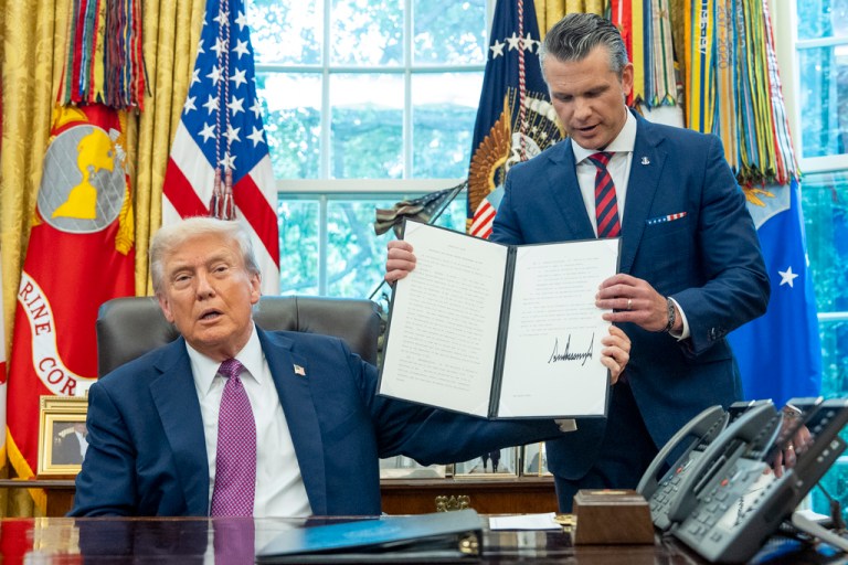 President Donald Trump speaks as he hands a signed executive order to Defense Secretary Pete Hegseth, in the Oval Office of the White House, Friday, Sept. 5, 2025, in Washington.
