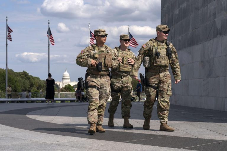 Members of the Louisiana National Guard patrol the grounds of the Washington Monument at the National Mall, Sunday, Sept. 7, 2025, in Washington. (AP Photo/Jose Luis Magana)