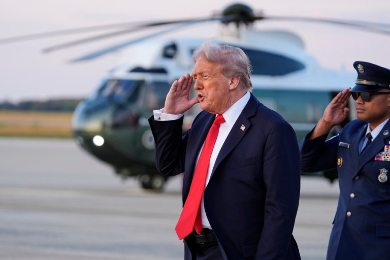 President Donald Trump salutes after deplaning Air Force One.