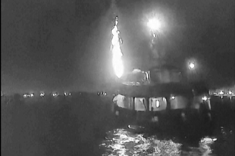 A ship from the Global Sumud Flotilla with a fire in the back of the boat.