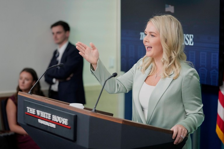 Karoline Leavitt gestures and speaks to reporters at a White House press briefing.
