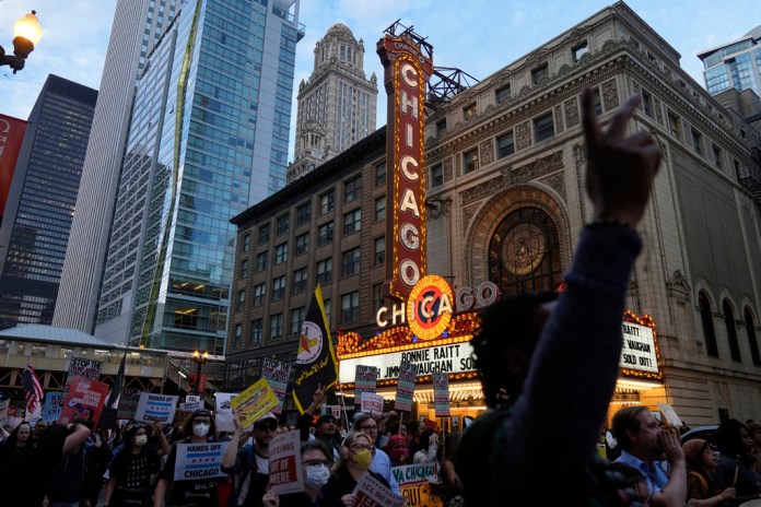 Crowds of people protest ICE presence in Chicago during "Operation Midway Blitz."