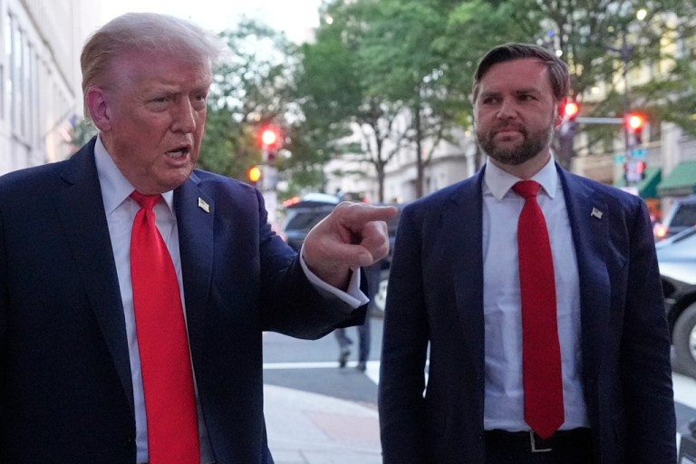 President Donald Trump stands next to Vice President JD Vance.