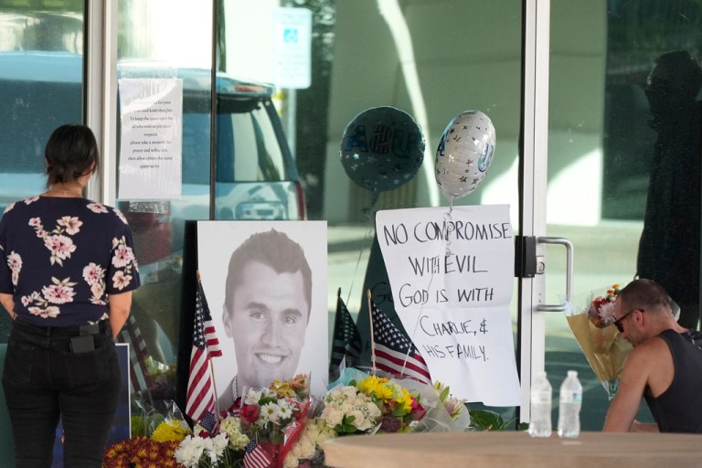 Well-wishers pay their respects at a makeshift memorial at the national headquarters of Turning Point USA shown after the shooting death of Charlie Kirk, the co-founder and CEO of the organization, during a Utah college event Wednesday, Sept. 10, 2025, in Phoenix.