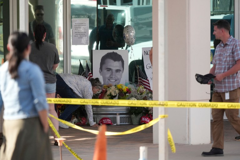 Well-wishers pay their respects at a makeshift memorial at the national headquarters of Turning Point USA after the shooting death of Charlie Kirk, CEO of the organization, during a Utah college event Wednesday, Sept. 10, 2025, in Phoenix.