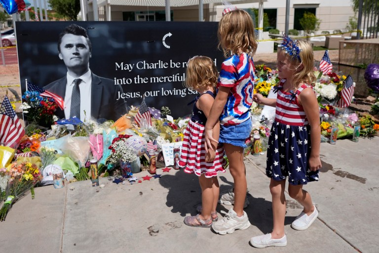Sisters Clara Hetland, 4, left, Haddie Hetland, center, 9, and Audra Hetland 6, of Surprise, Ariz., spend time at a makeshift memorial set up at Turning Point USA headquarters after the shooting death at a Utah college on Wednesday of Charlie Kirk, the co-founder and CEO of the organization, Thursday, Sept. 11, 2025, in Phoenix.