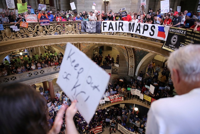 Protestors gather in the rotunda of the Missouri State Capitol to protest.