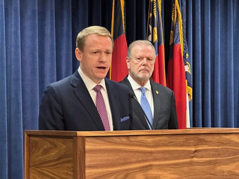 North Carolina state House Speaker Destin Hall speaks while state Senate leader Phil Berger listens.