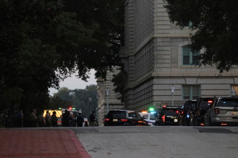 Officers are seen on the grounds of the U.S. Naval Academy during a campus lockdown.