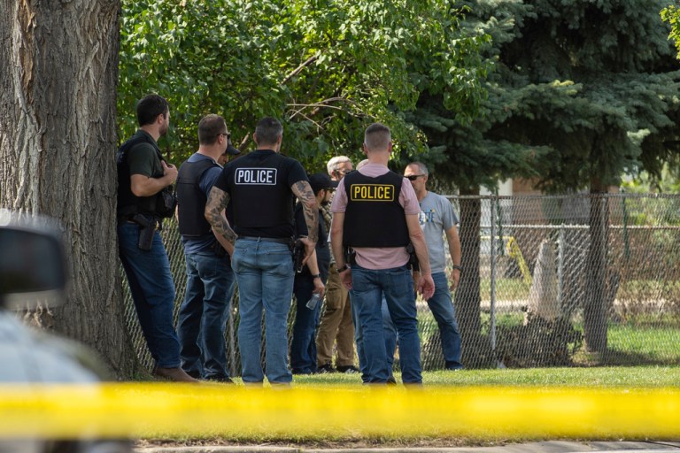 Law enforcement personnel investigate after the Department of Homeland Security said an Immigration and Customs Enforcement agent fatally shot a man in the Franklin Park suburb of Chicago on Friday, Sept. 12, 2025. (Candace Dane Chambers/Chicago Sun-Times via AP)