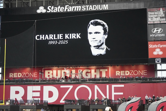 The scoreboard displays the likeness of Charlie Kirk prior to an NFL football game between the Carolina Panthers and the Arizona Cardinals.