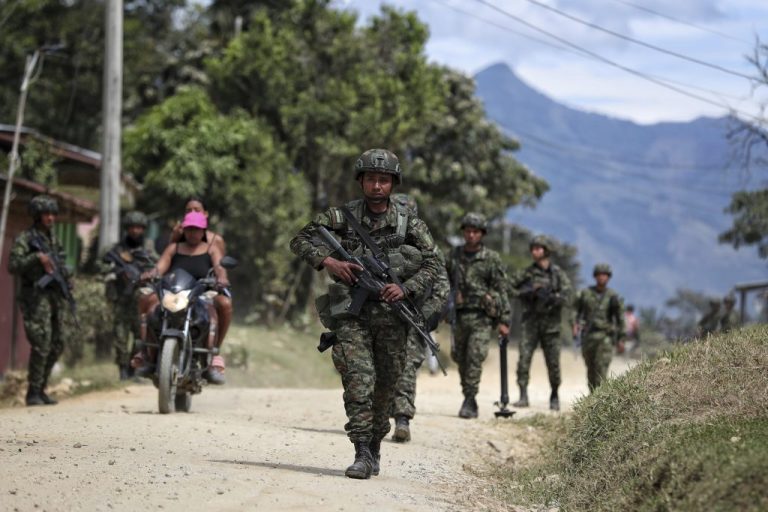 Soldiers patrol a street in El Carmelo, Colombia, a day after a deadly attack on a police station that authorities blame on a dissident faction of the demobilized Revolutionary Armed Forces of Colombia (FARC), Monday, Sept. 15, 2025.