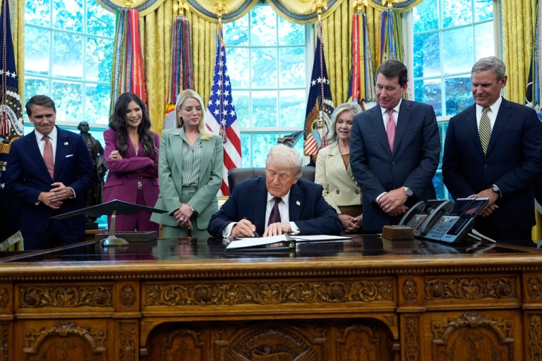President Donald Trump signs a memorandum titled 