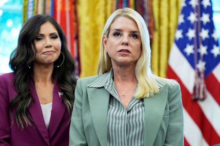 Attorney General Pam Bondi, right, and Homeland Security Secretary Kristi Noem listen as President Donald Trump speaks in the Oval Office of the White House, Monday, Sept. 15, 2025, in Washington. (AP Photo/Alex Brandon)