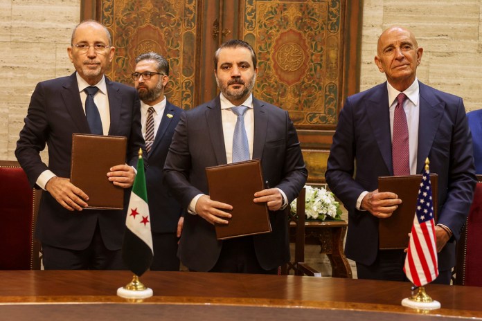U.S. Ambassador to Turkey and Special Envoy to Syria Tom Barrack, right, Jordanian Foreign Minister Ayman Safadi, left, and Syrian Foreign Minister Asaad al Shibani pose for a photograph after signing a road map to restore security in southern Syria, in Damascus, Syria, Tuesday, Sept. 16, 2025.