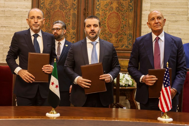 U.S. Ambassador to Turkey and Special Envoy to Syria Tom Barrack, right, Jordanian Foreign Minister Ayman Safadi, left, and Syrian Foreign Minister Asaad al-Shibani pose for a photograph after signing a roadmap to restore security in southern Syria, in Damascus, Syria, Tuesday, Sept. 16, 2025.