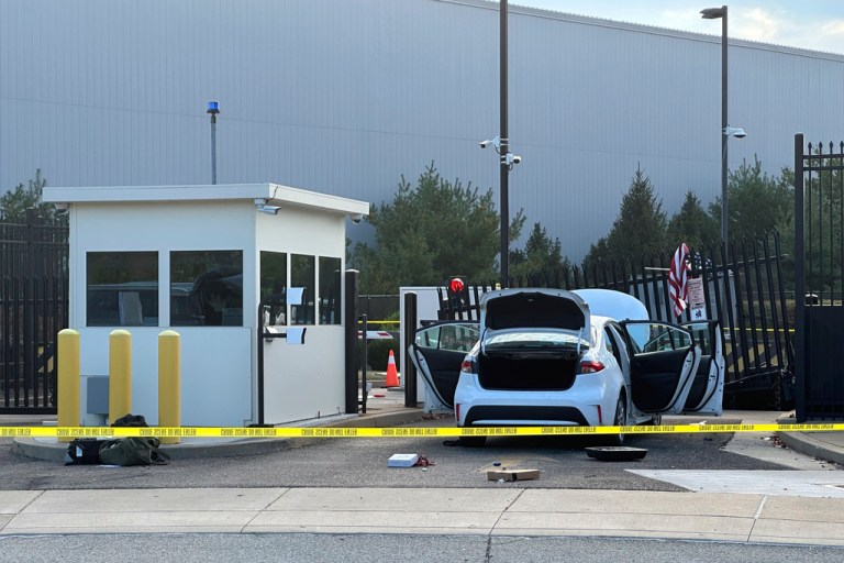FBI officials inspect a car that rammed into a gate at the FBI building in Pittsburgh, Wednesday, Sept. 17, 2025.