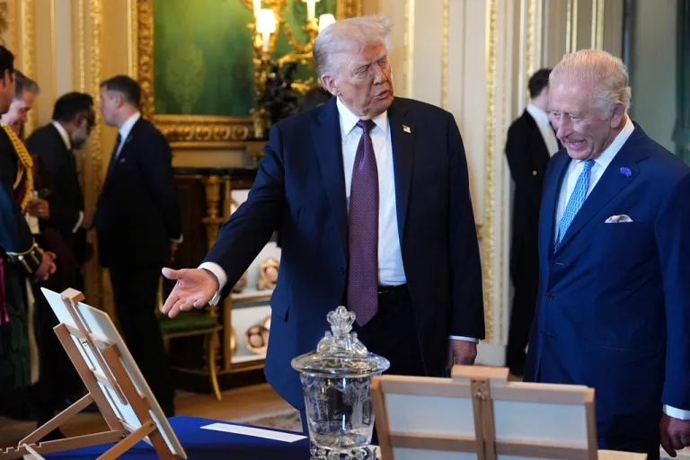 President Donald Trump speaks with Britain's King Charles III as they view a special display of items from the Royal Collection relating to the United States of America, in the Green Drawing Room at Windsor Castle, in Windsor, England, Wednesday, Sept. 17, 2025.