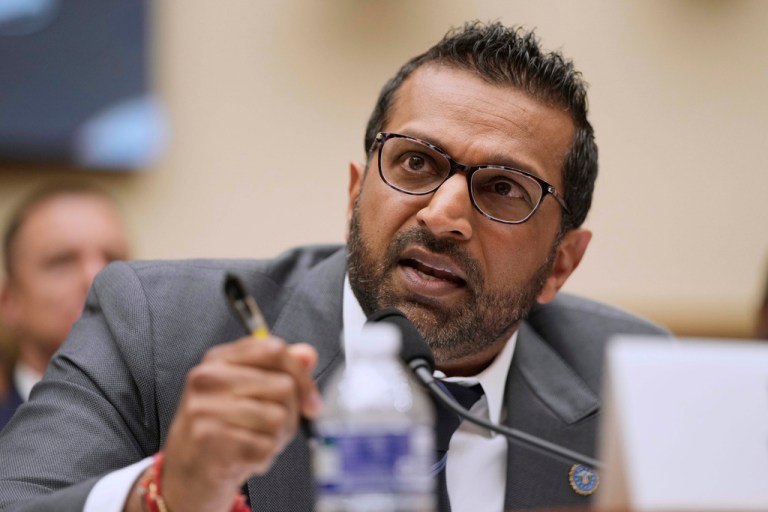 FBI Director Kash Patel speaks into a microphone.