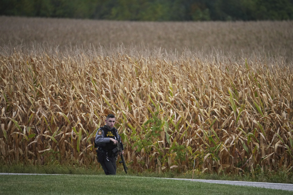 A Pennsylvania state police trooper patrols a road after multiple police officers were shot and killed on Wednesday, Sept. 17, 2025, in North Codorus, Pennsylvania. 
