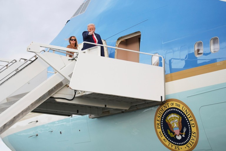 President Donald Trump gestures as he boards Air Force One with first lady Melania Trump at Stansted airport, Thursday, Sept. 18, 2025, in Stansted, England