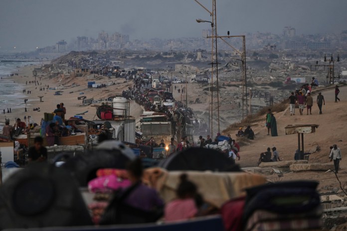 Displaced Palestinians flee Gaza City on foot and in vehicles.