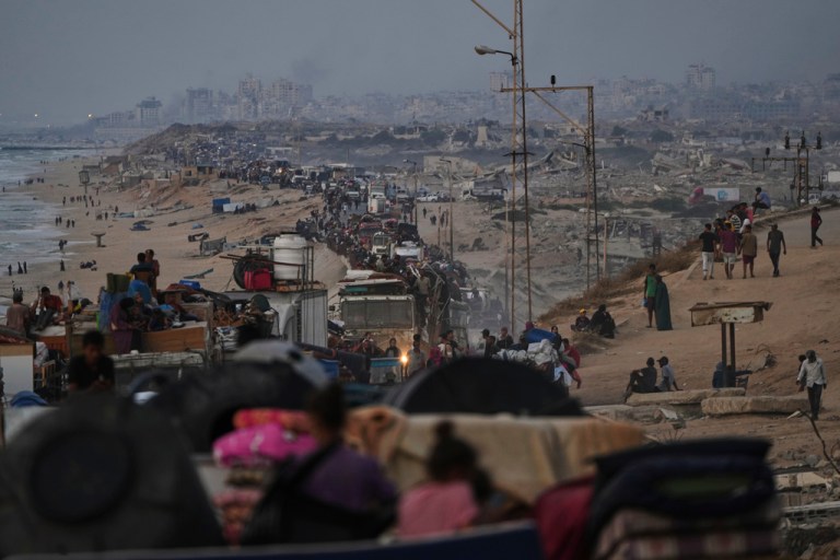 Displaced Palestinians flee Gaza City on foot and in vehicles.
