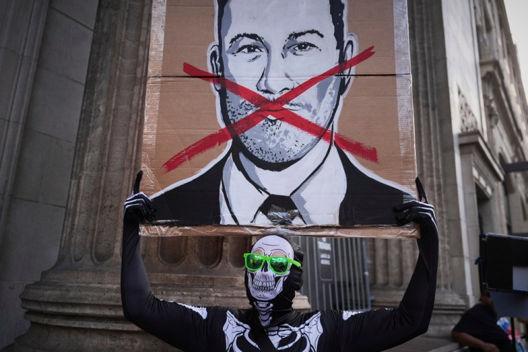 Asher Rogers holds an image of Jimmy Kimmel outside El Capitan Entertainment Centre, where the late-night show 