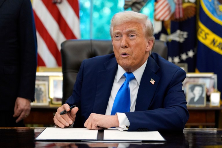 President Donald Trump signs the Gold Card executive order in the Oval Office of the White House, Monday, Sept. 15, 2025, in Washington.