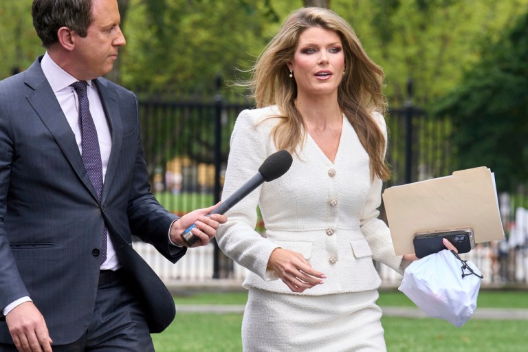 Lindsey Halligan, special assistant to the president, speaks with a reporter outside of the White House, Wednesday, Aug. 20, 2025, in Washington
