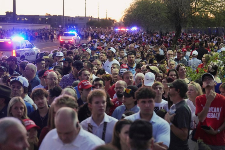 People wait in line before a memorial for conservative activist Charlie Kirk Sunday, Sept. 21, 2025, at State Farm Stadium in Glendale, Ariz. (AP Photo/Jae C. Hong)