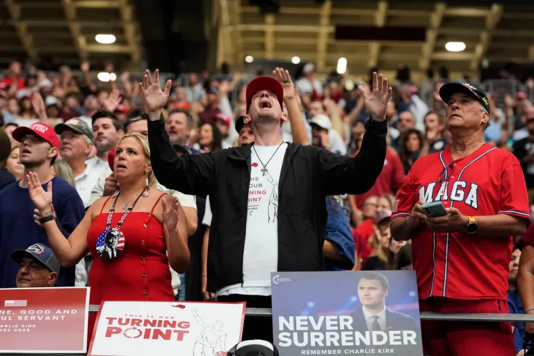 A man listens during a worship song before the start of a memorial for conservative activist Charlie Kirk, Sunday, Sept. 21, 2025, at State Farm Stadium in Glendale, Ariz. (AP Photo/Ross D. Franklin)